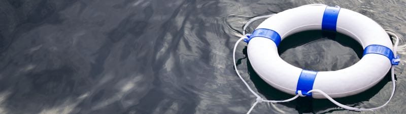 Life preserver floating in dark water